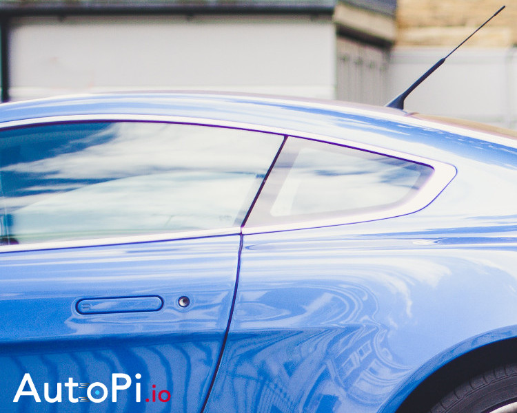 A zoomed in photo of a blue car explaining how can autopi control the car window