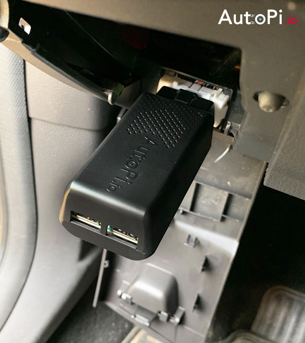 A detailed shot of AutoPi telematics unit generation 2 plugged into obd 2 port