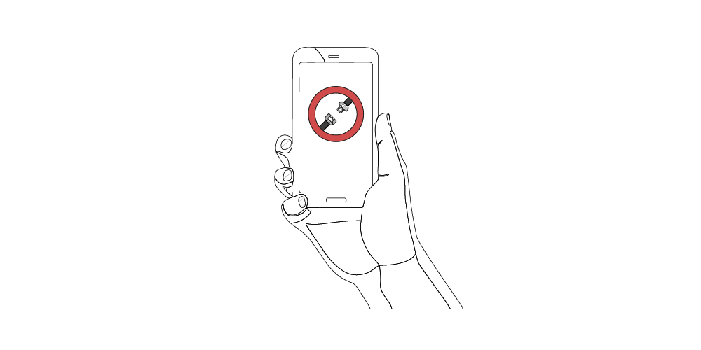 A person holding a smartphone with a remote seatbelt notification on